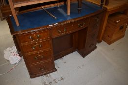 An early 20th Century mahogany bow fronted desk, labelled Bopwith and Co, Newcastle