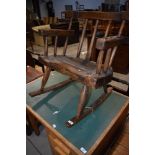 A rustic low rocking chair