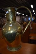 A large brass flagon style jug