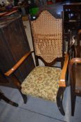 A traditional stained frame armchair having bergere back