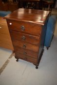 An early 20th Century oak narrow chest of five drawers