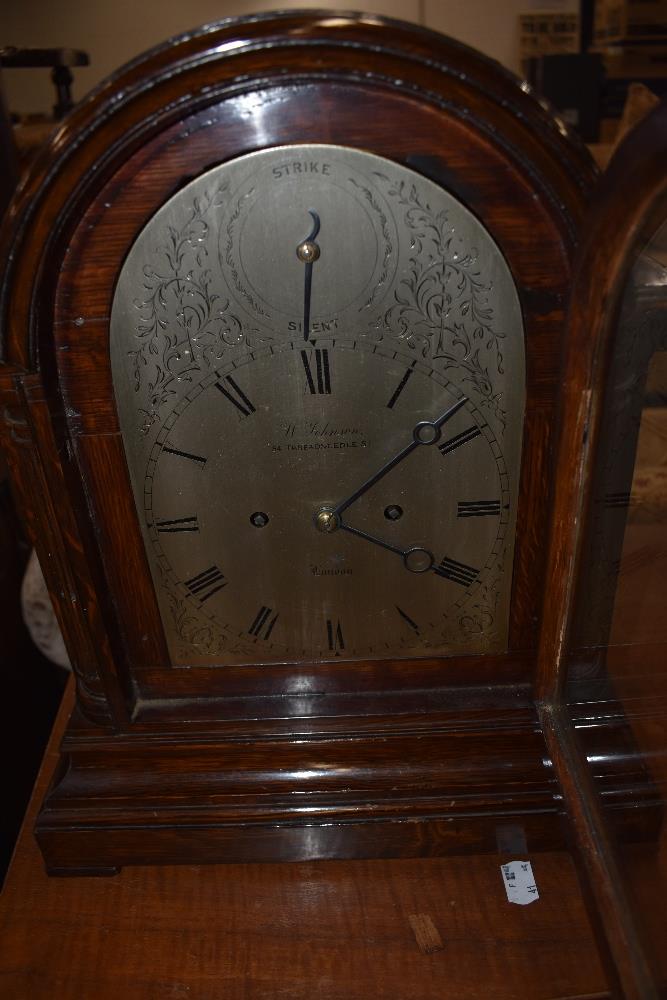 A late 19th/early 20th Century oak cased bracket clock , having silvered dial signed W Johnson,