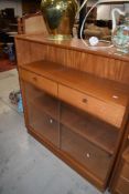 A Nathan side bookshelf with open shelf over two drawers, glass fronted shelves under