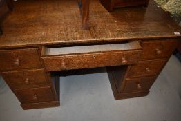 An early 20th Century oak desk, Waring & Gillow
