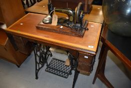 A late 19th Singer sewing machine, with treadle base