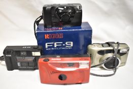 Four cameras. A fujifilm zoom date 90, a Halina Vision 400, a Kodak 35EF, and a boxed Ricoh FF9