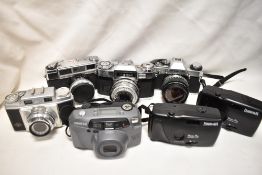 A collection of cameras and equipment. Cameras include Zeiss Ikon Contraflex, Agfa Super Sillette, a