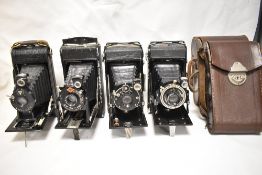 Four folding cameras. A Zeiss Ikon, A Zeiss Ikonta, an Agfa and a Goerz