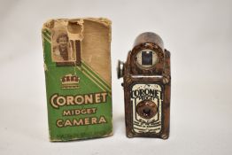 A Coronet Midget camera in brown marble bakelite with original box
