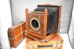 A mahogany plate camera in box with three film holders (no lens)