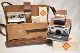A Polaroid SX 70 Land camera with lens shade, accessory holder, remote shutter button in original
