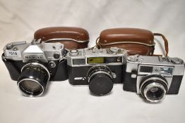 Three cameras. A Taron VL camera with Taronar 1:2,8 45 mm lens, a Mamiya no model number (spares and