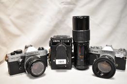 A selection of cameras. A Canon Pellix with a Canon FL 50mm 1:1;8 lens, a Praktica MLT50 with