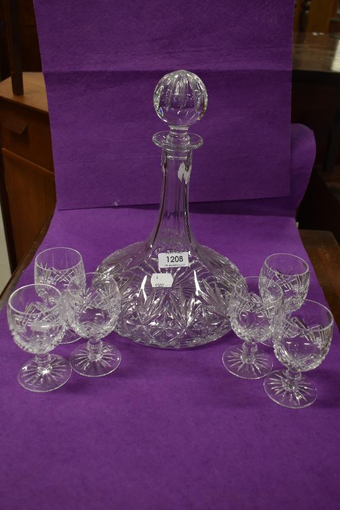 A fine clear cut crystal glass decanter and brandy glass set