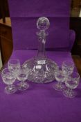 A fine clear cut crystal glass decanter and brandy glass set