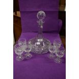 A fine clear cut crystal glass decanter and brandy glass set