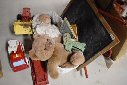 A shelf of vintage Toys including Triang Blackboard, Loading Shovel and plastic Fire Engine etc