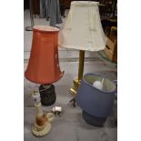 Four bedside lamps of various designs and sizes.