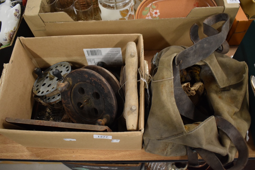 A canvas bag and a box of vintage fishing tackle and reels.