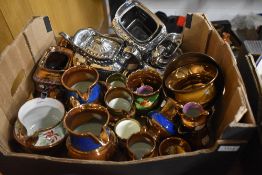 An assortment of lustre ware including jugs, bowls and teapots.