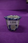 A small Chinese blue and white ware pot having lattice pierced sides on six footed base