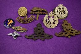 A selection of 20th century military badges and cap pins etc