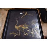 A large late 19th century Japanese lacquer serving tray decorated with stalks and landscape