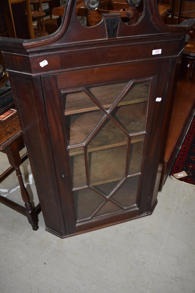 A 19th Century mahogany corner display cabinet having astral glazed door and line inlay decoration