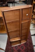 An Ercol mid stain wall shelf, width approx. 107cm