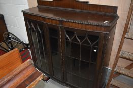 A late 19th or early 20th Century mahogany display cabinet , leg AF
