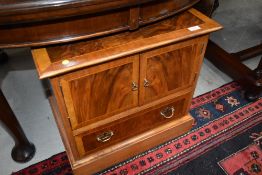 A nice quality reproduction yew wood TV cabinet having faux drawer fronts