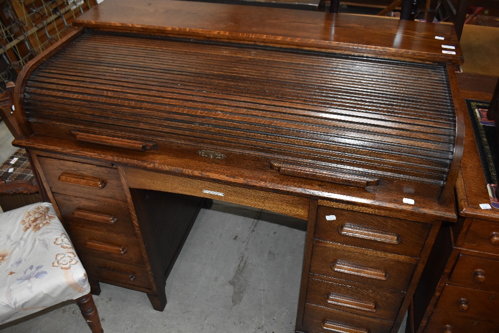 A late 19th or early 20th Century oak roll top desk, retailed by Withy Grove Stores, Manchester