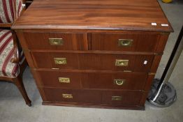 A modern campaign style chest having three drawers and one faux drawer drop flap