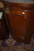 A 19th Century oak bow fronted corner cupboard
