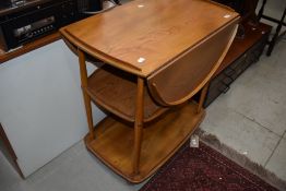 An Ercol tea trolley having drop flap and shelf under