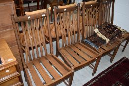 A set of Ercol dining chairs dark stained dining chairs, in a simple style