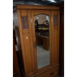 A Victorian satinwood wardrobe