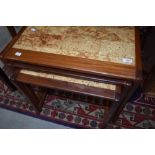 A vintage teak and tile top nest of three tables