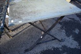 A cast frame garden table having slate top
