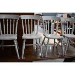 A set of four painted kitchen chairs