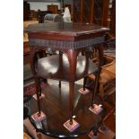 A late Victorian mahogany occasional table having hexagonal top and undershelf on fine legs