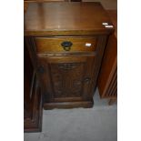 A reproduction oak side cabinet having drawer and cupboard under