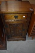A reproduction oak side cabinet having drawer and cupboard under