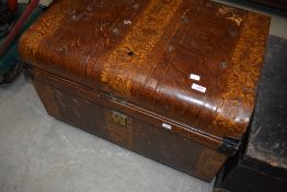 A vintage travel trunk having scumbled style decoration