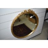 A gilt framed wall mirror with bow decoration to top