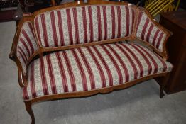 A Continental style walnut settee having shaped frame and classical striped upholstery