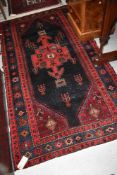 A Persian style rug, approx. 210 x 110cm