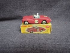 A Dinky diecast, 107 Sunbeam Alpine, Maroon with Cream Hubs, in original correct spot box