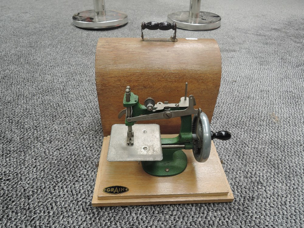 A Grain Child's Sewing Machine in wooden carry case