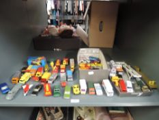 A shelf of playworn diecasts including Matchbox, Dinky, Corgi Juniors and similar